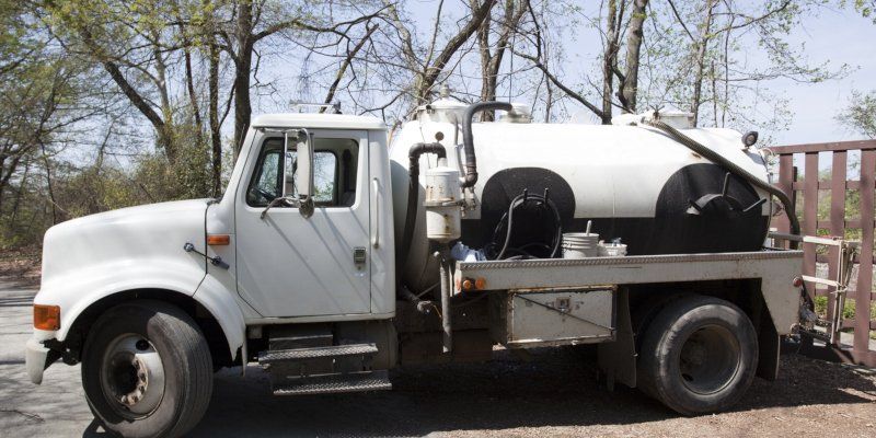 Septic Truck and Trees — Greenville, SC — American Waste Septic Septic Truck and Trees — Greenville, SC — American Waste Septic