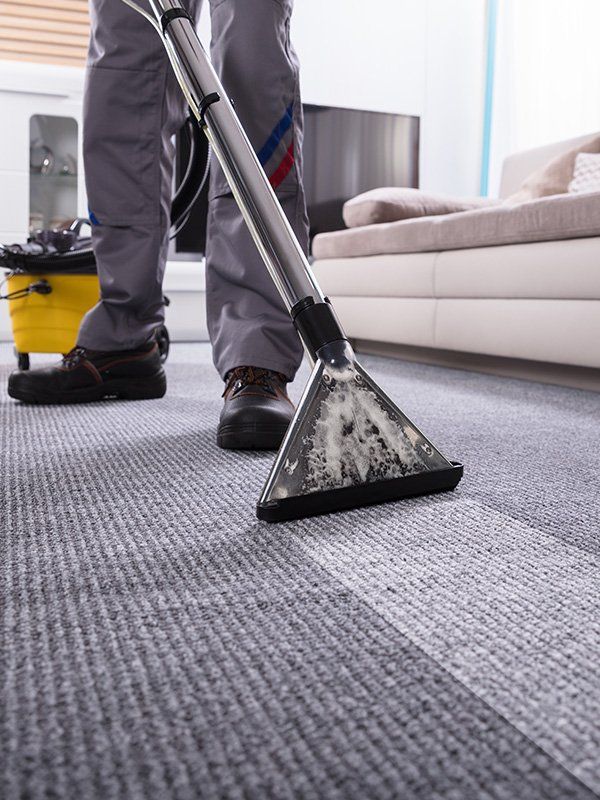 Man Cleaning Carpet Using Vacuum — Carpet Cleaning In Townsville QLD Man Cleaning Carpet Using Vacuum — Carpet Cleaning In Townsville QLD