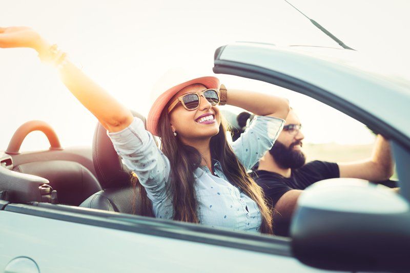 General Liability — Couple Riding a Car Happily in Decatur, GA General Liability Agency