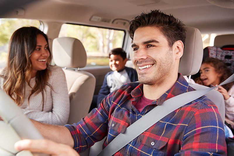 Car Insurance — Man Driving a Car with His Family in Decatur, GA Car Insurance Agency