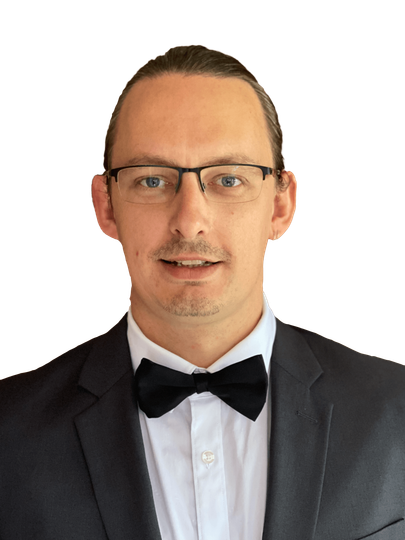 A man in a suit and bow tie is smiling for the camera