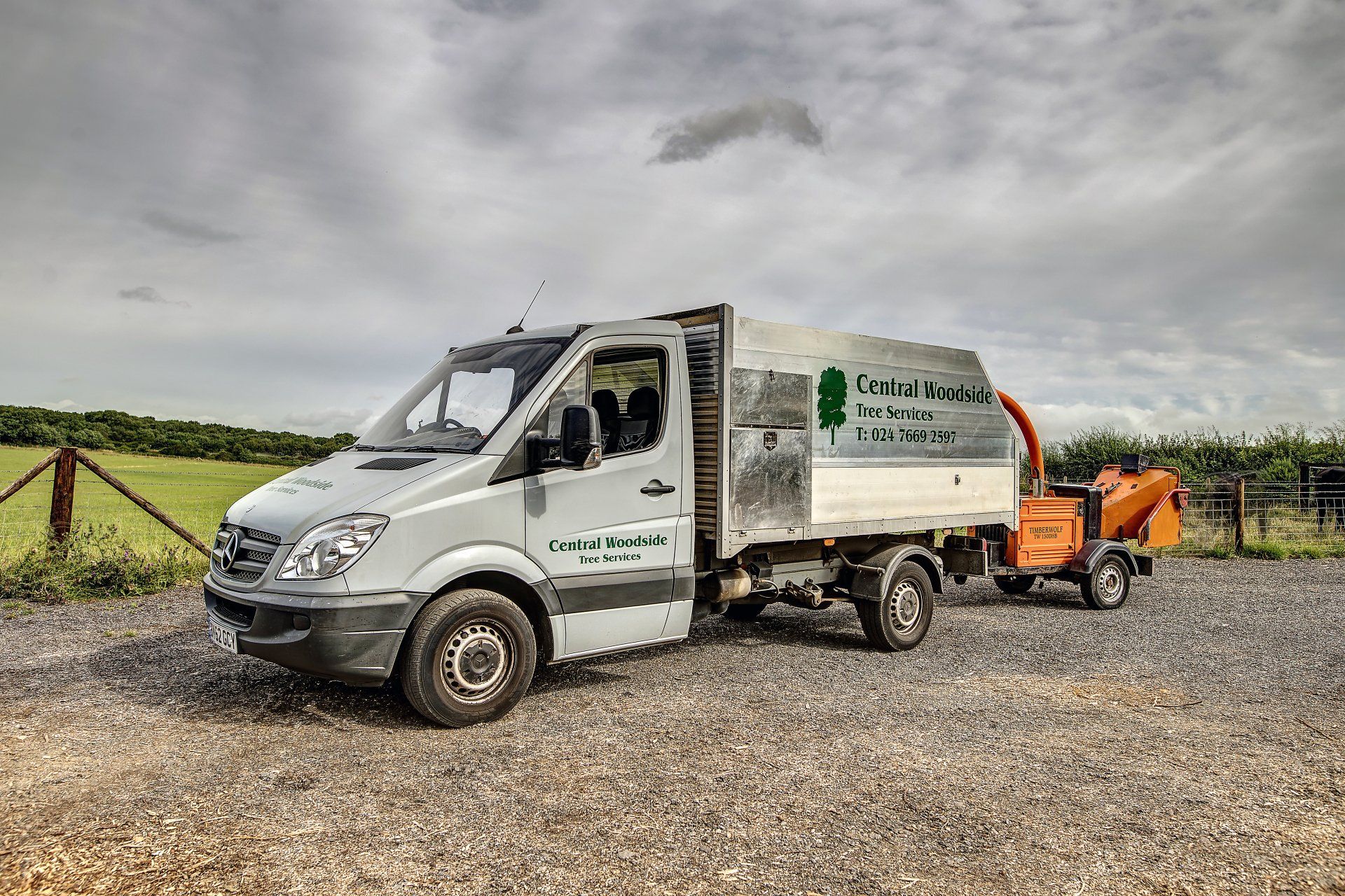Central Woodside Tree Services Vehicle towing a wood chipper