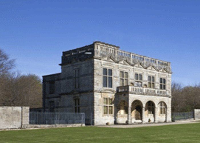 A large stone building with arched windows and a balcony