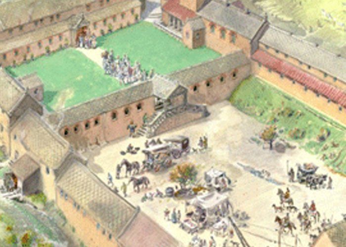 An aerial view of a castle with horses and carriages.