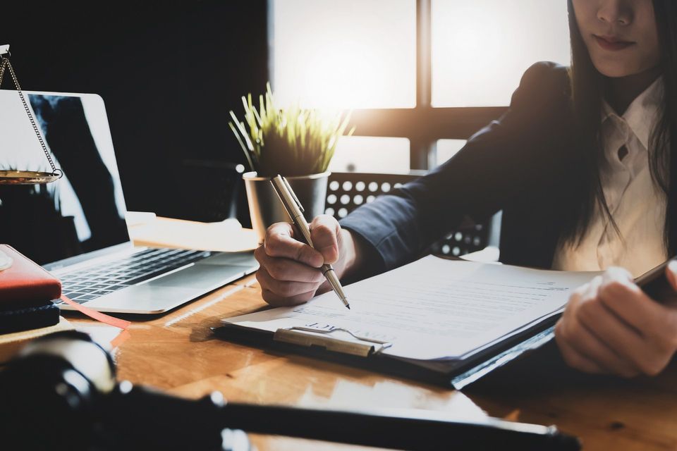 Lawyer Woman Holding Pen — Greenville, SC — McMaster Law Firm LLC Lawyer Woman Holding Pen — Greenville, SC — McMaster Law Firm LLC