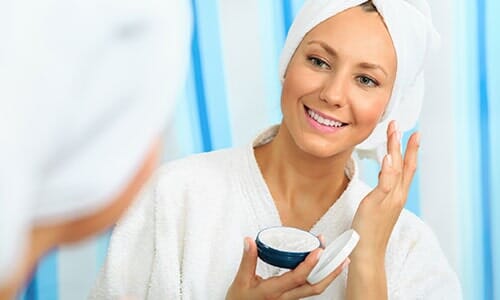 Woman Applying Skin Moisturizer — Products in New York, NY Woman Applying Skin Moisturizer — Products in New York, NY