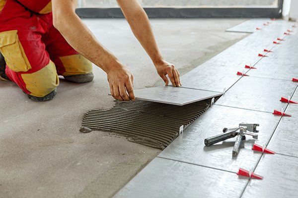 Worker Placing Ceramic Tile — Thatcher, AZ — Woodside Construction, LLC