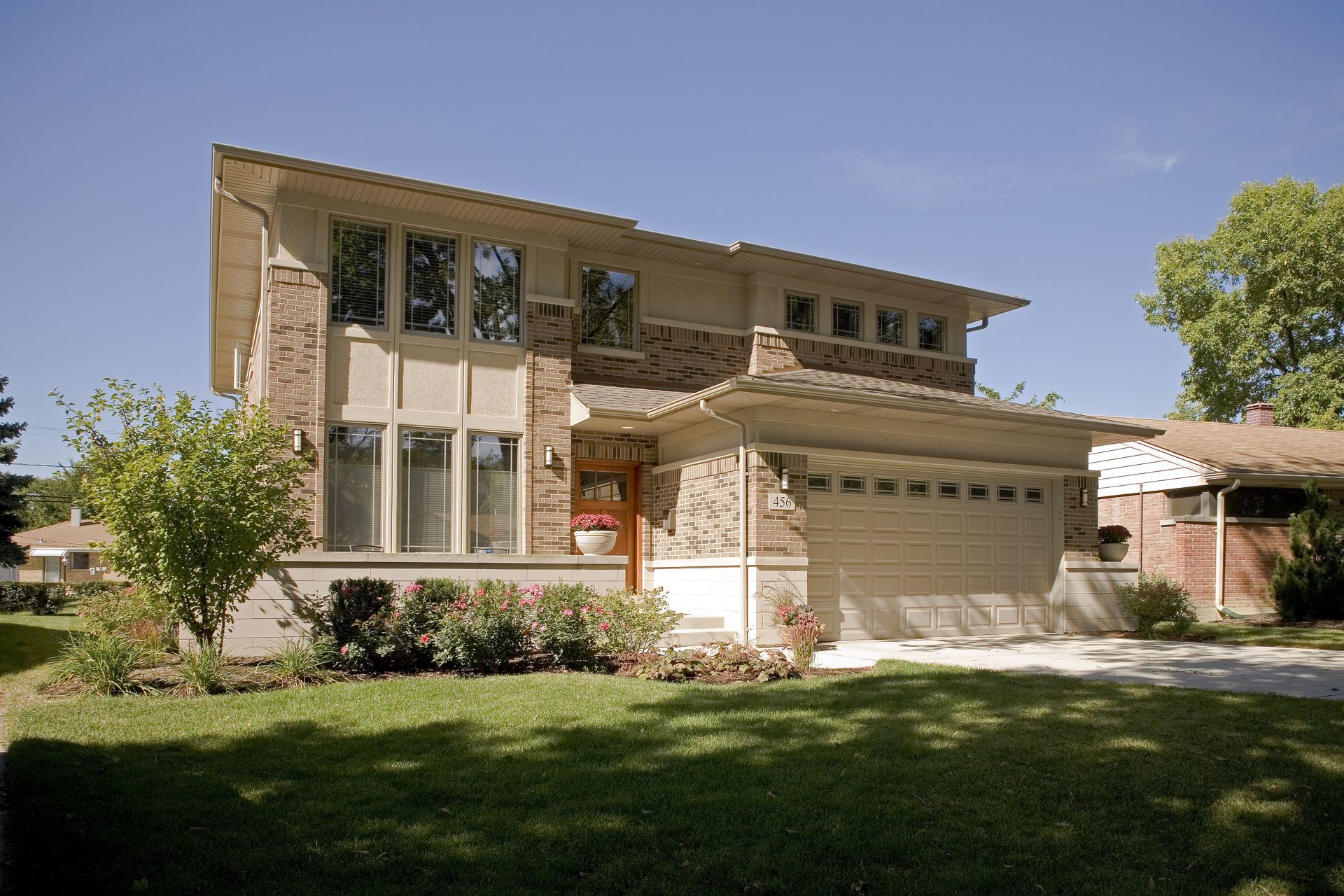 A large house with a garage and a lot of windows