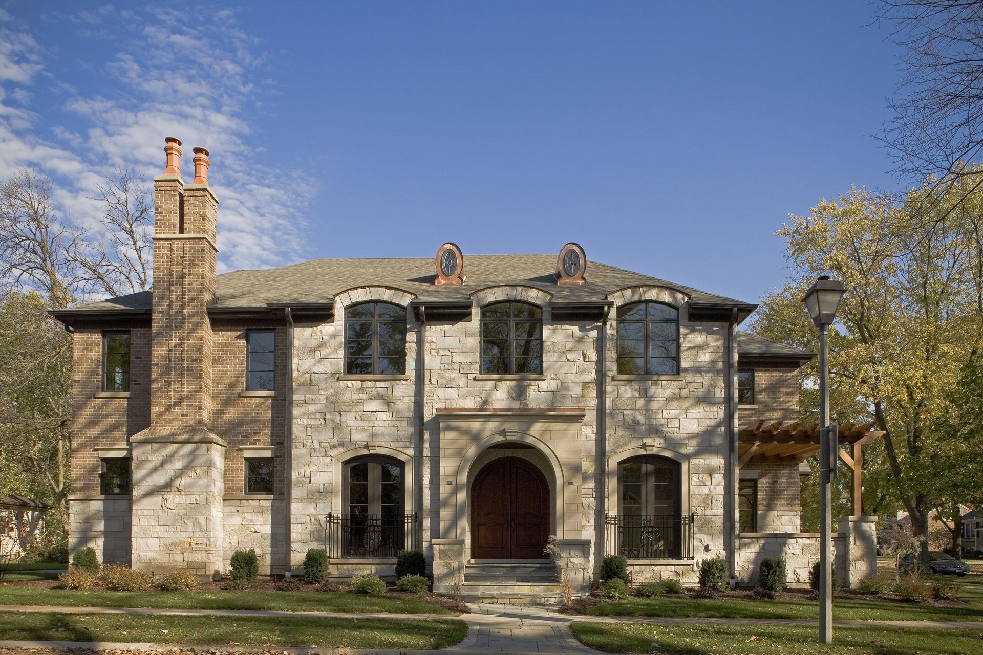 A large stone house with a lot of windows and chimneys