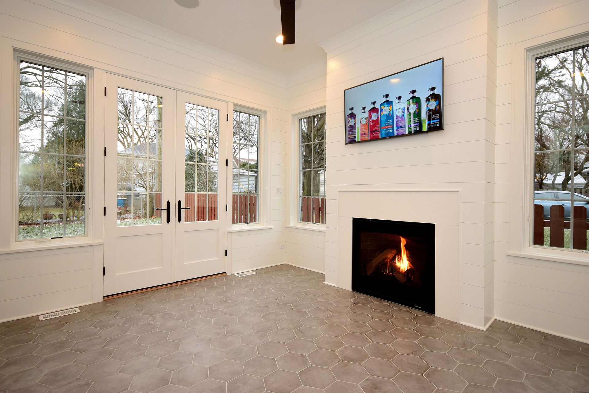 A living room with a fireplace and a flat screen tv on the wall