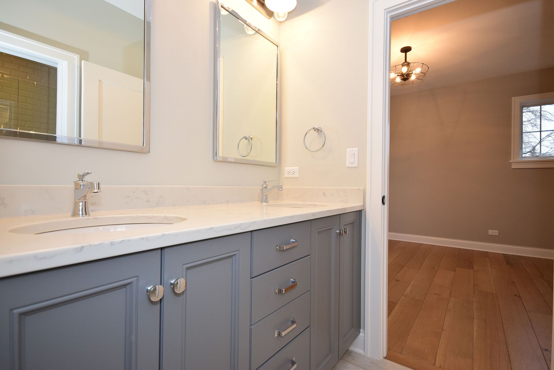 A bathroom with two sinks and a mirror.
