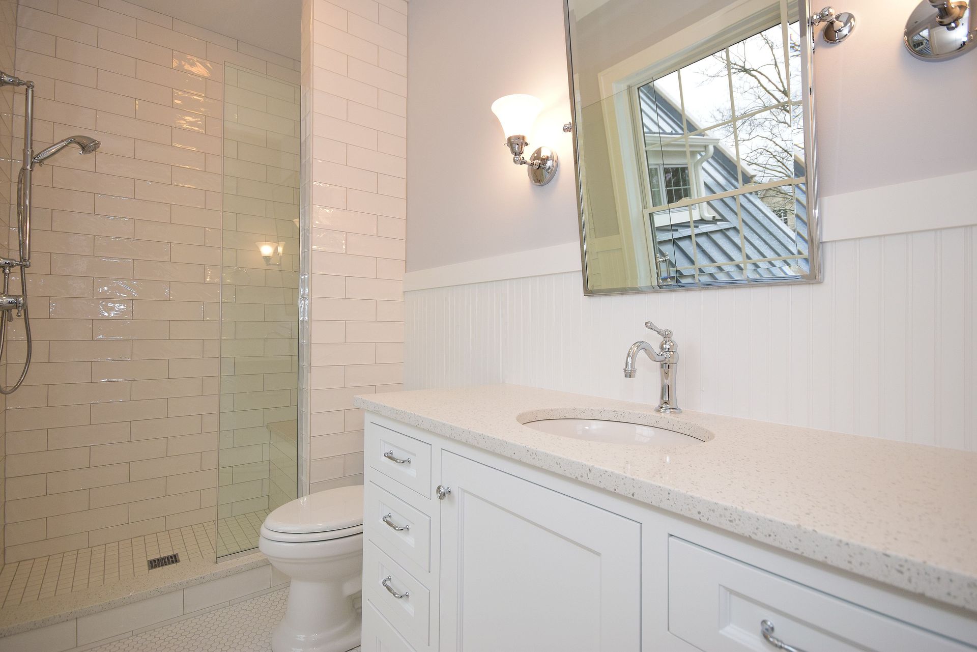 A bathroom with a toilet a sink and a mirror
