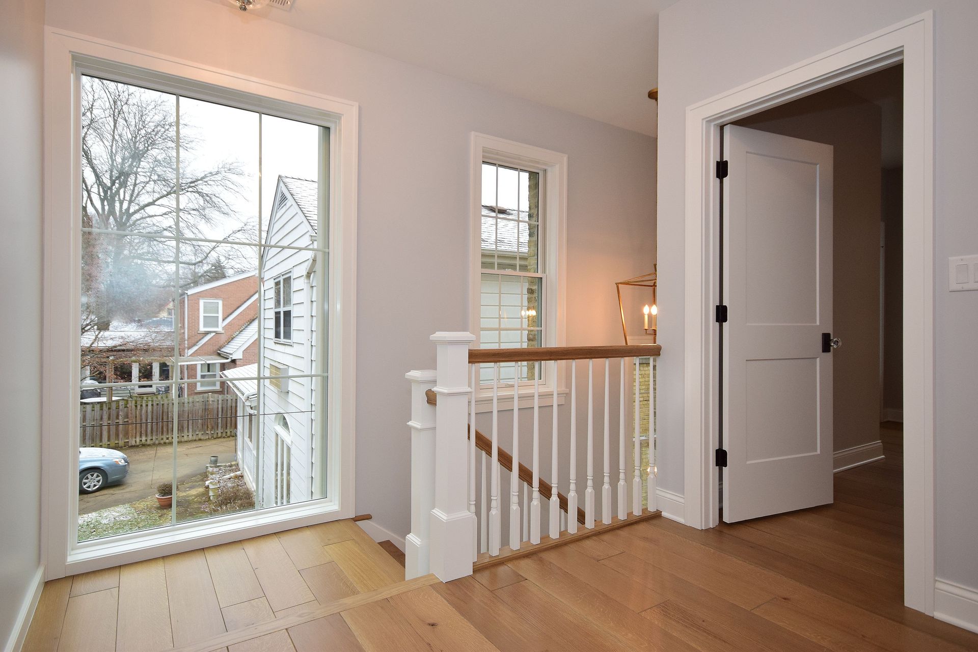 An empty room with a staircase and a large window.