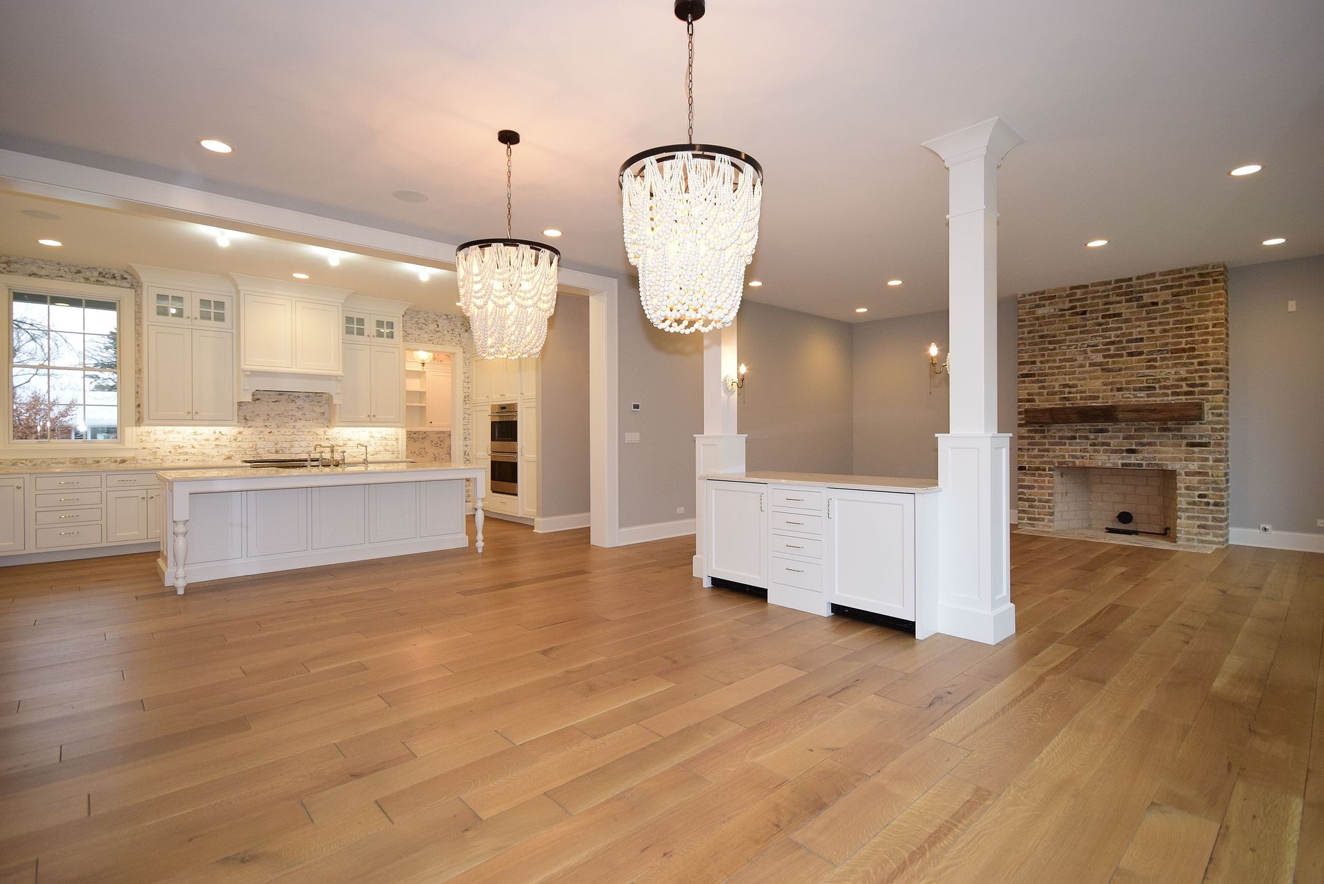 A large empty room with hardwood floors and a fireplace