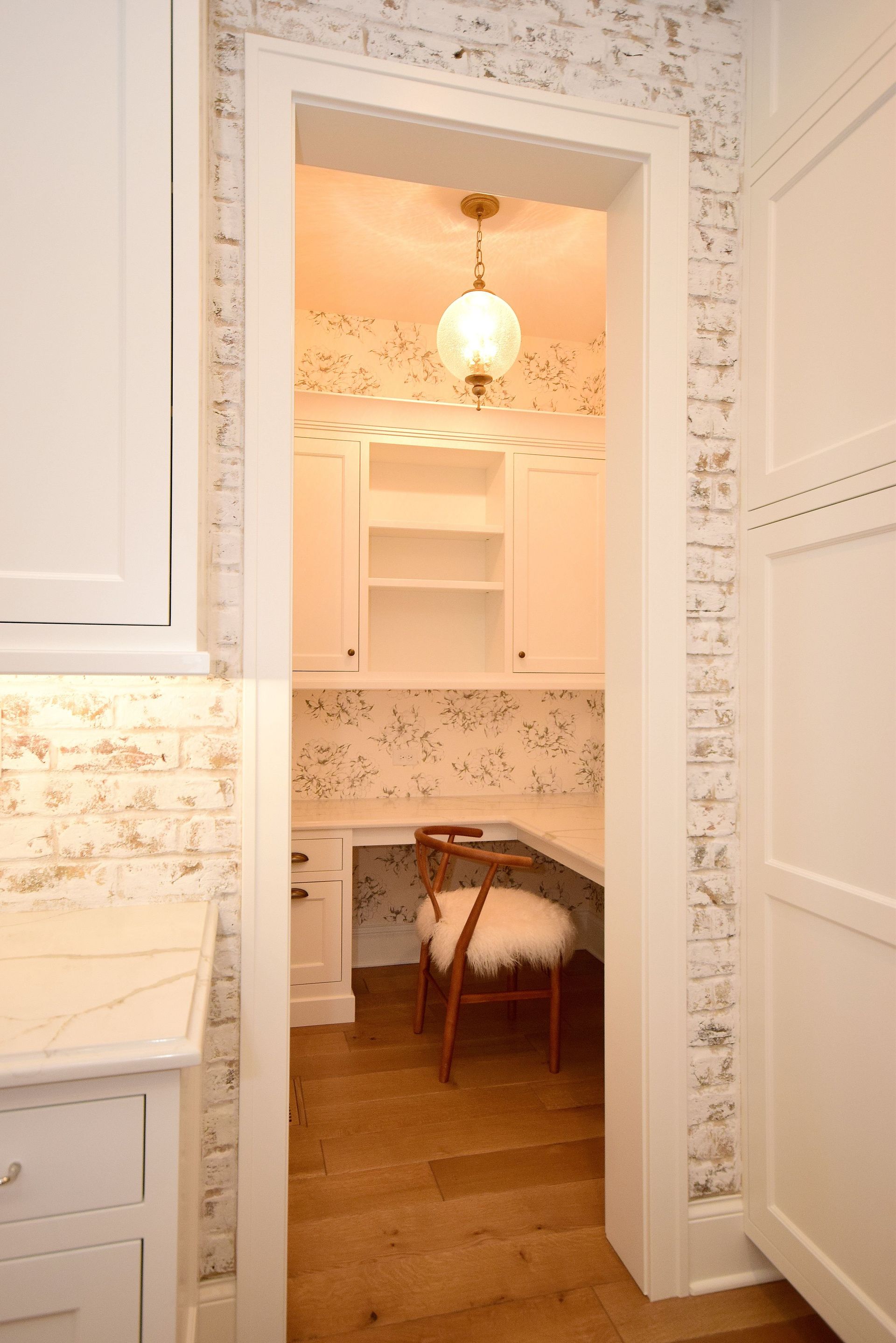 A small room with a desk and chair in it.