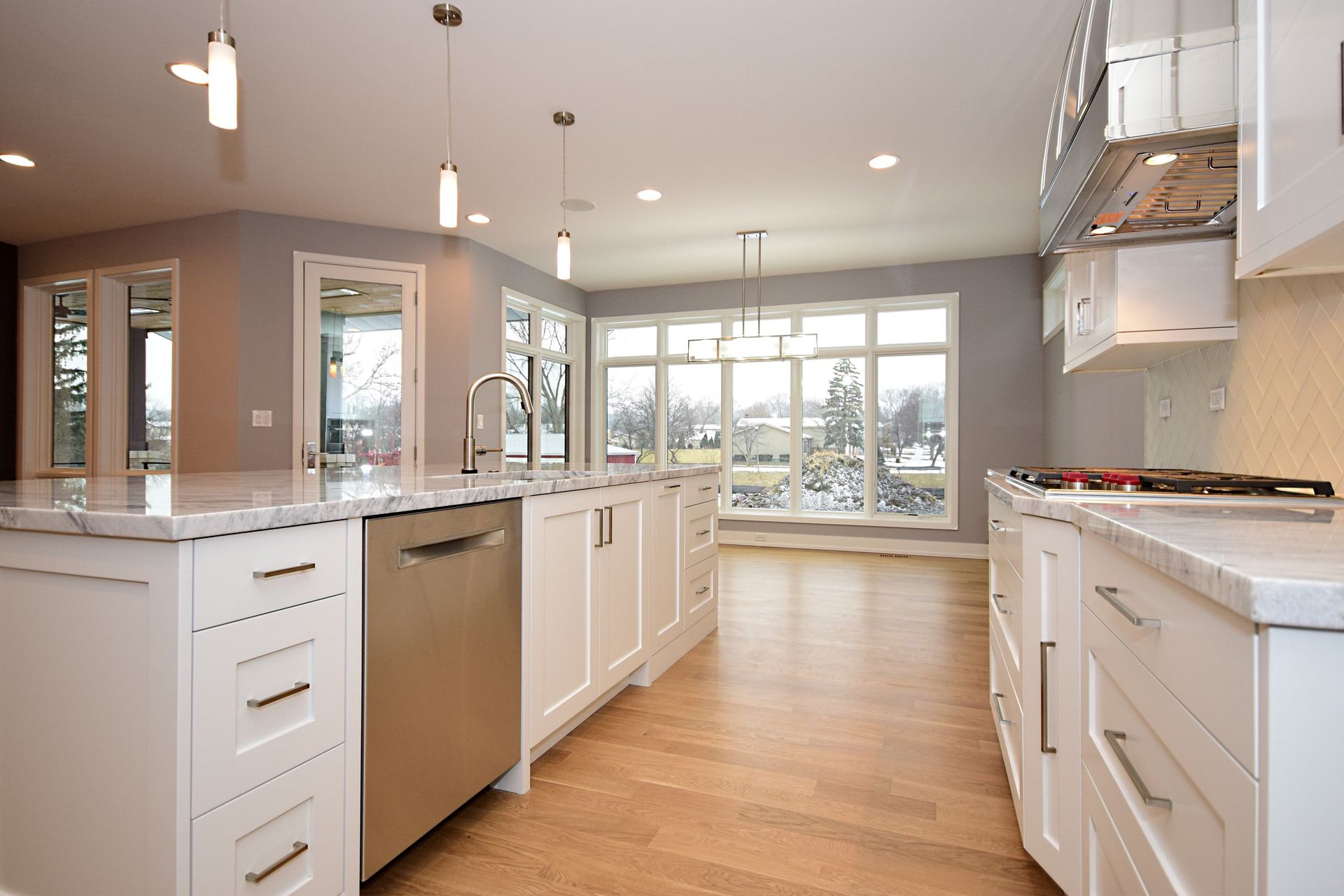 A kitchen with white cabinets and stainless steel appliances