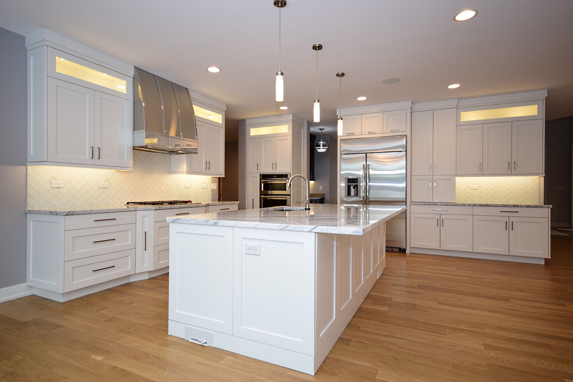 A kitchen with white cabinets and stainless steel appliances