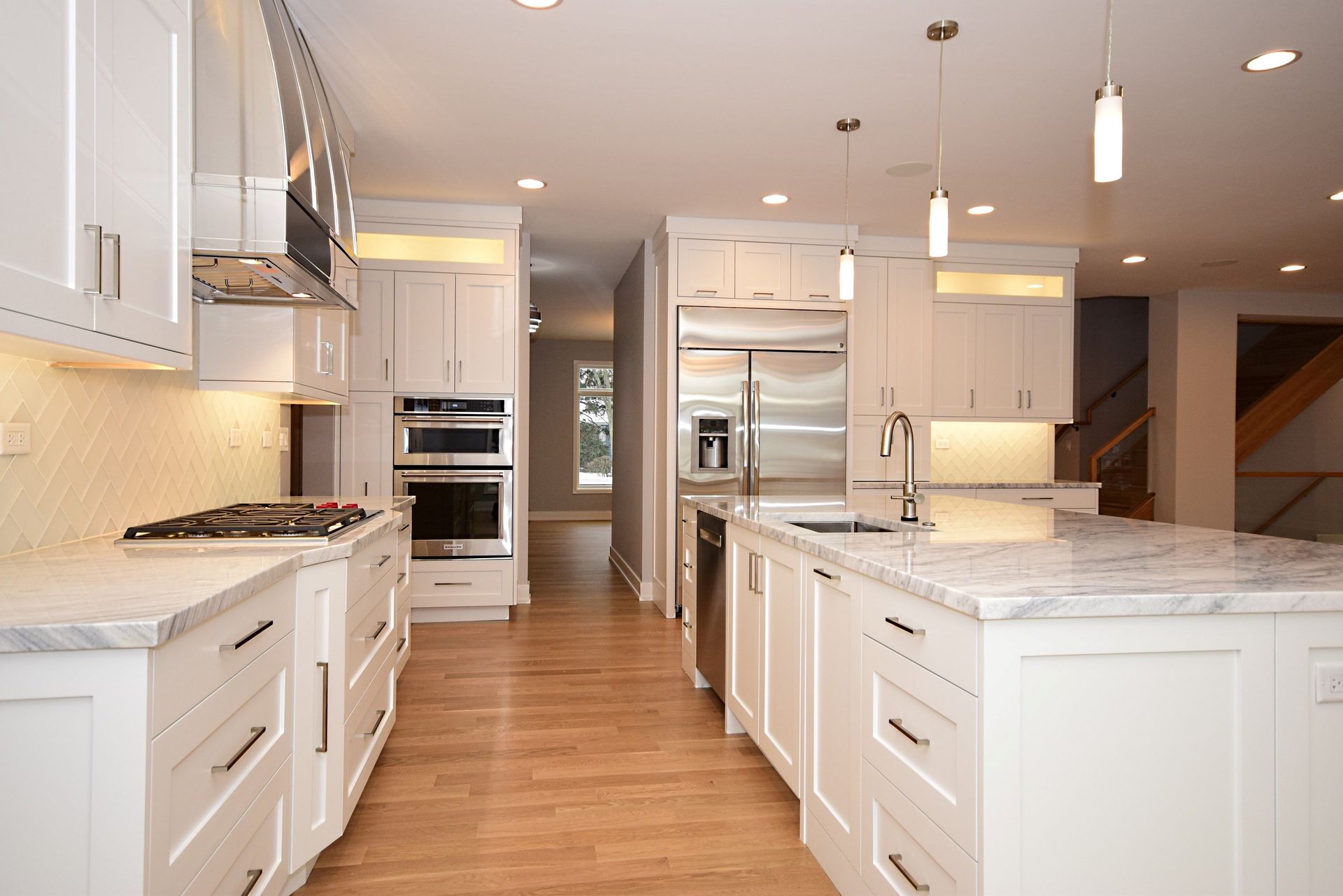A kitchen with white cabinets and stainless steel appliances