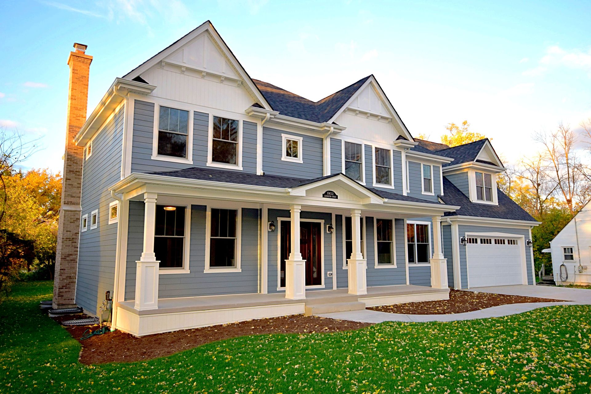 A large house with a lot of windows and a chimney