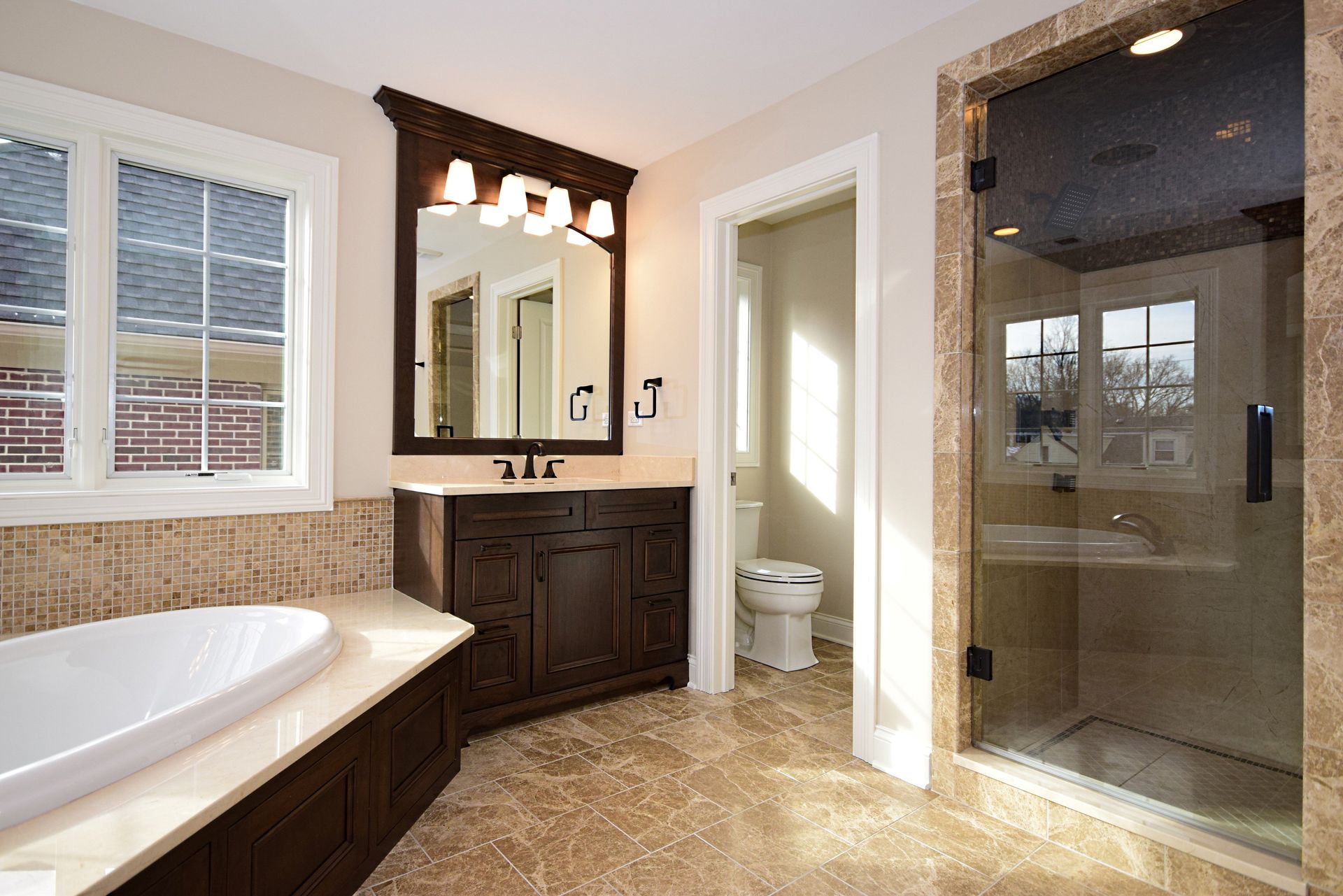 A bathroom with a tub , sink , toilet and shower.