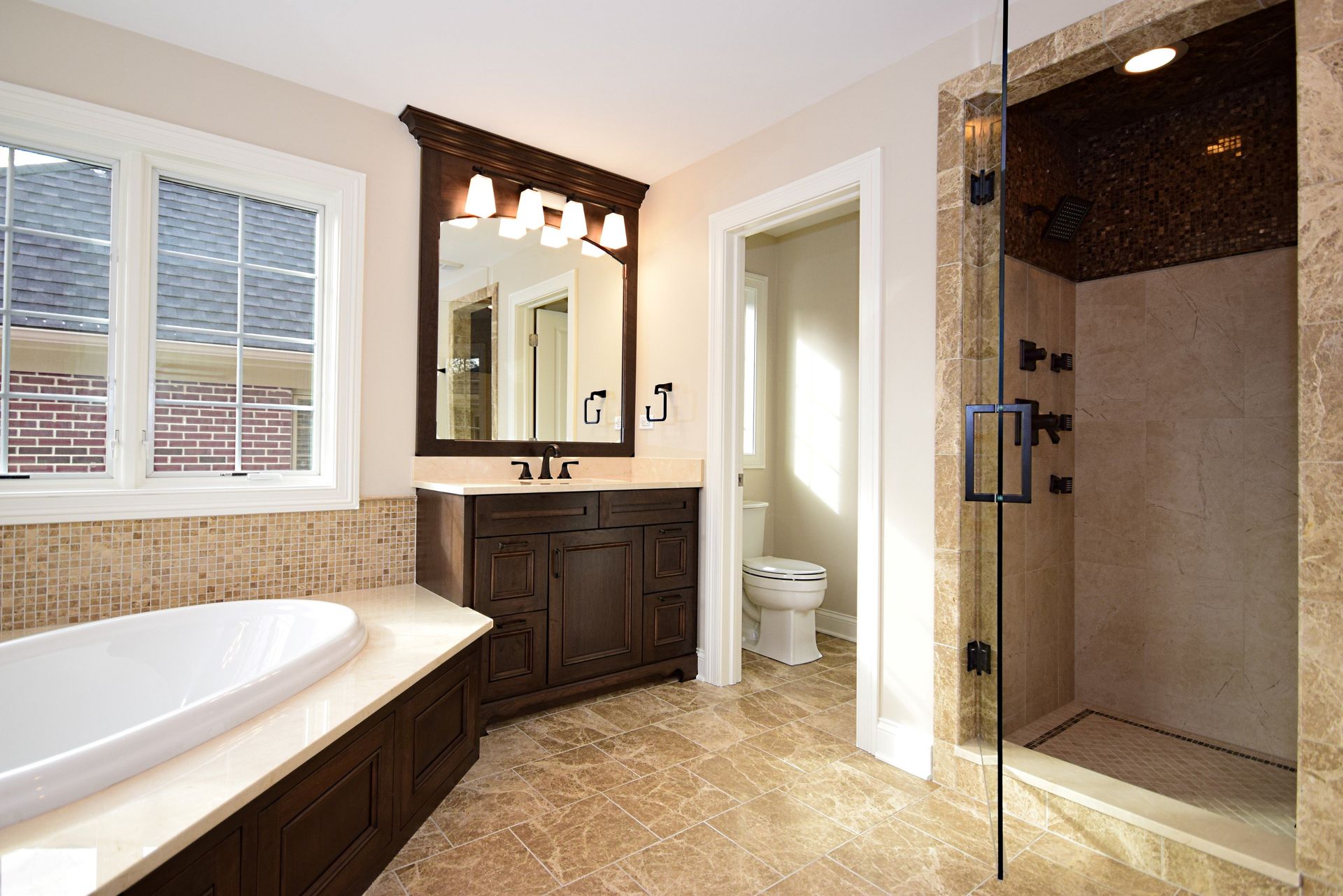 A bathroom with a tub , sink , toilet and shower.