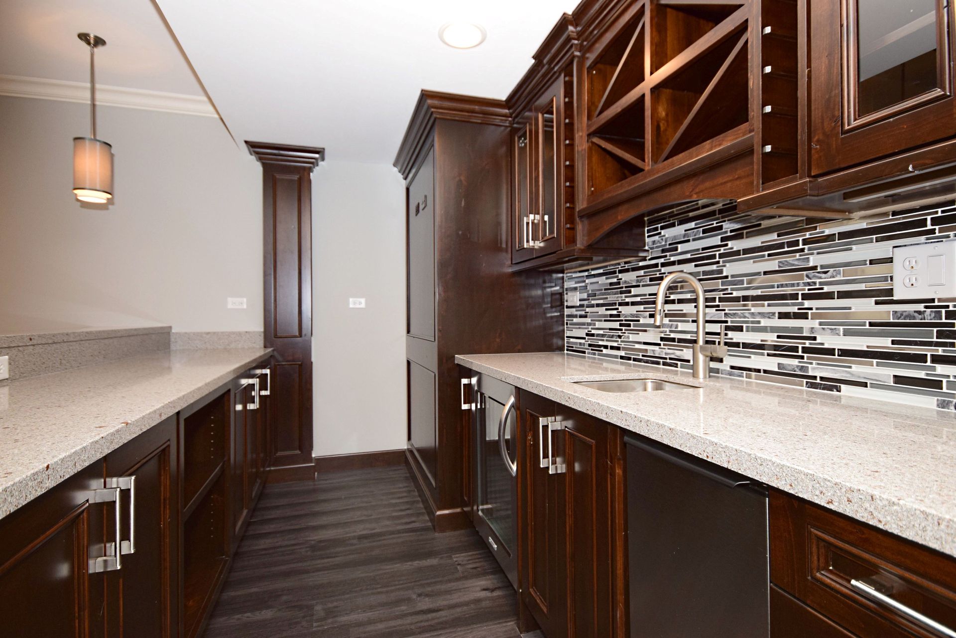 A kitchen with wooden cabinets and granite counter tops.