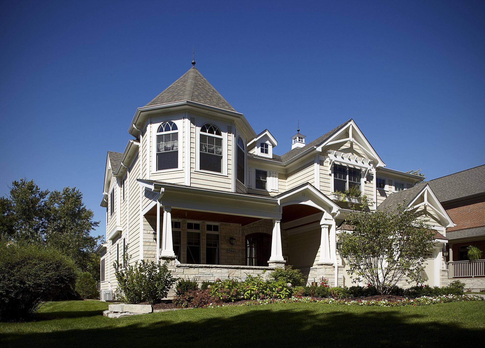 A large white house with a blue sky in the background