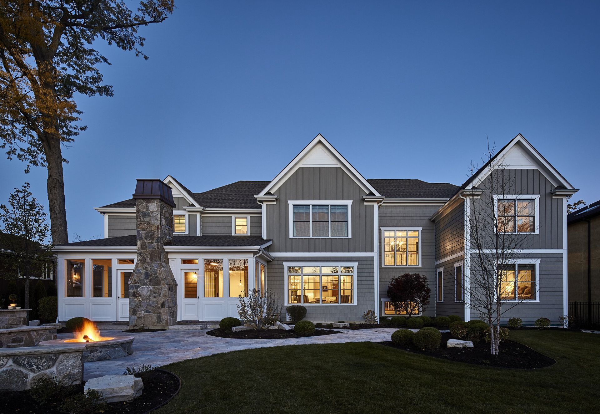 A large house with a fire pit in front of it