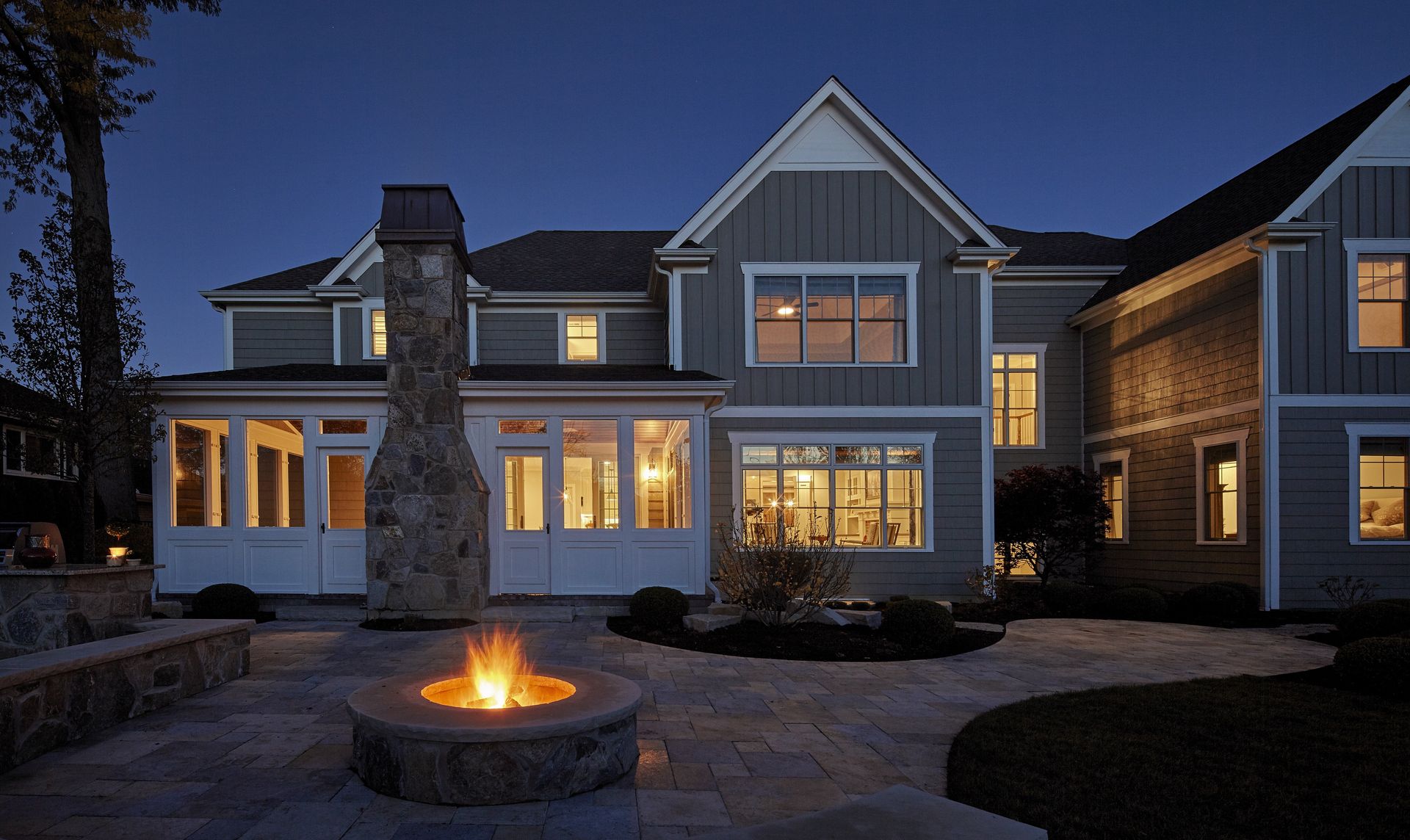 A large house with a fire pit in front of it