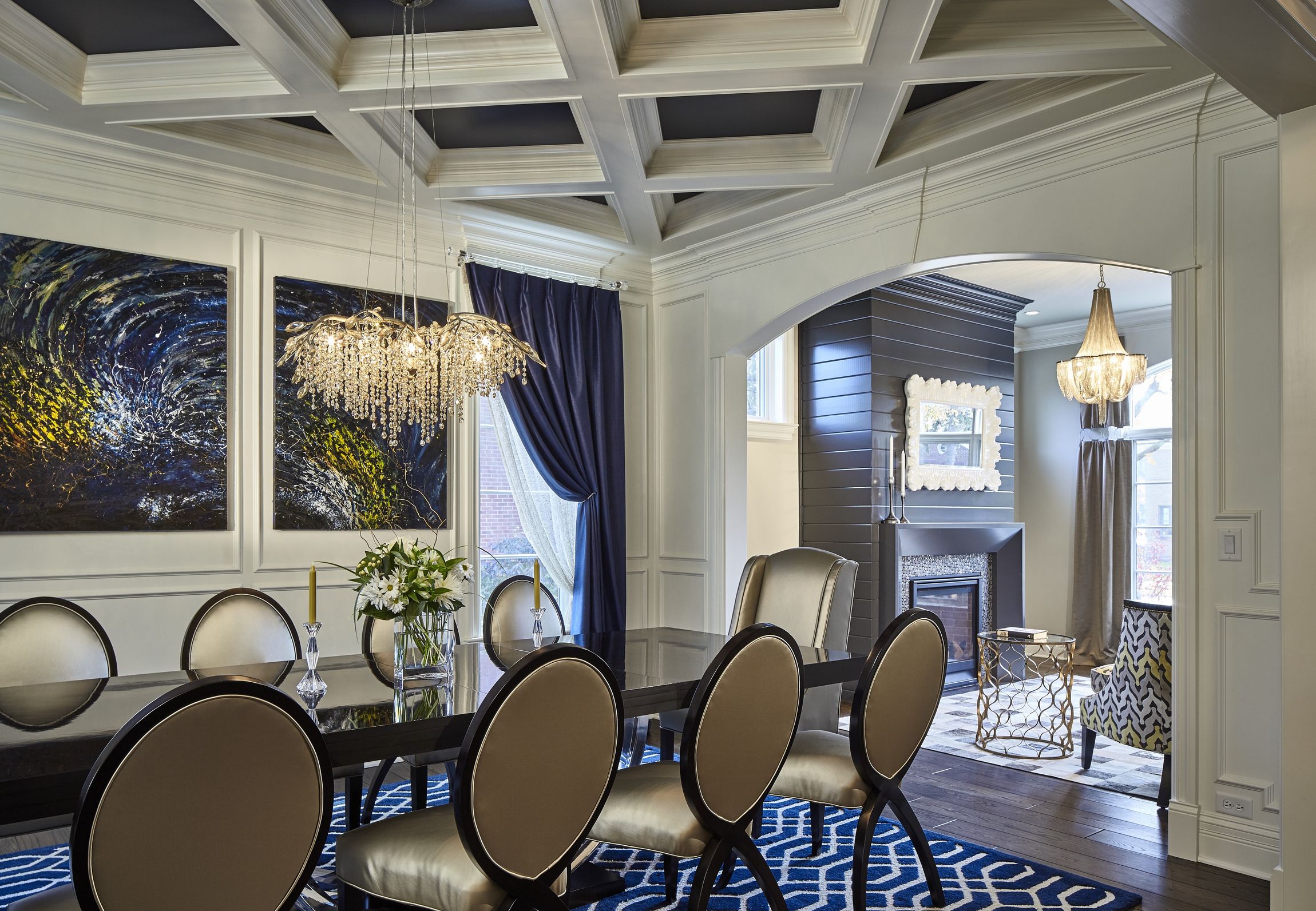 A dining room with a table and chairs and a chandelier