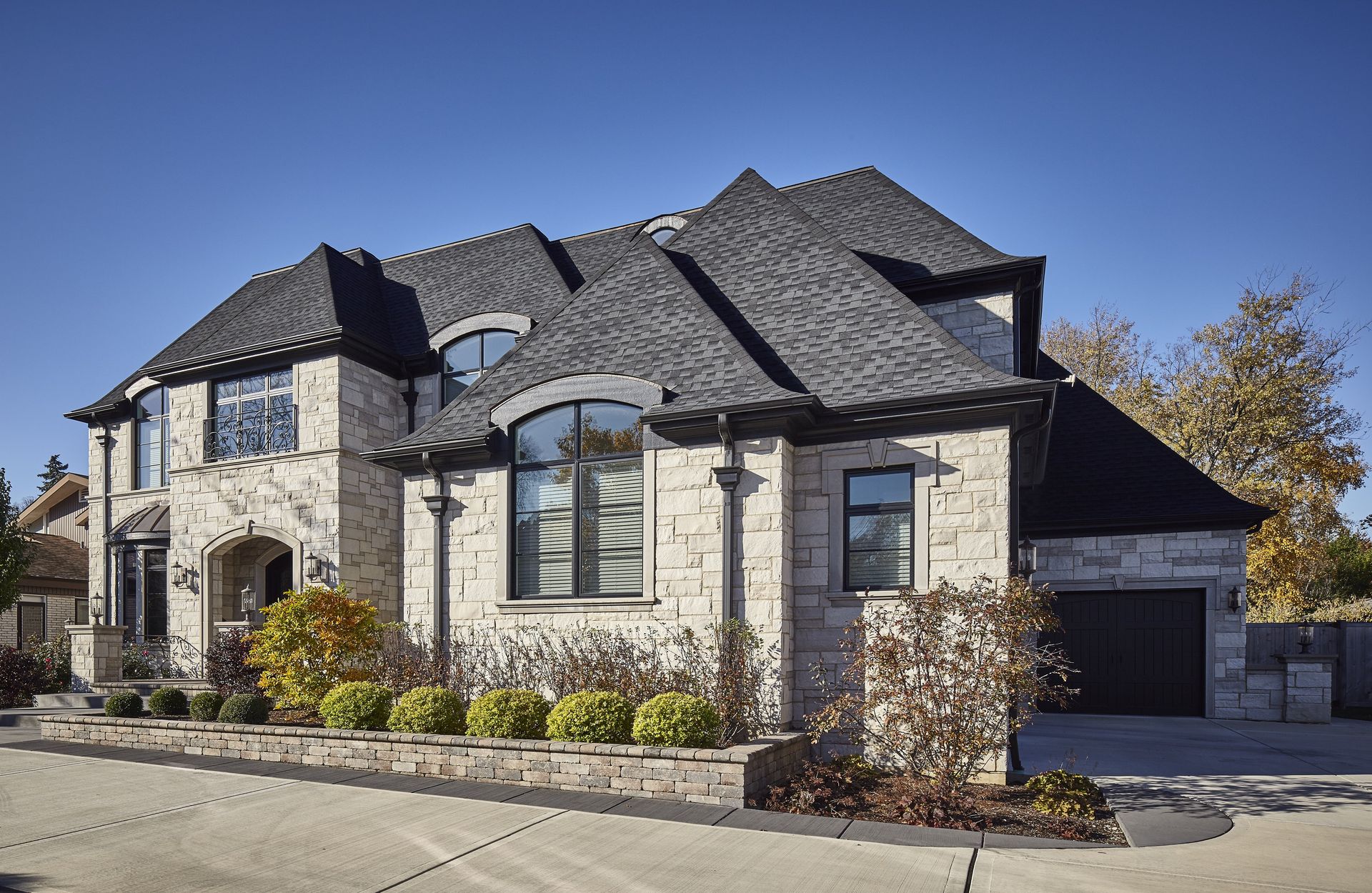 A large house with a gray roof and a lot of windows