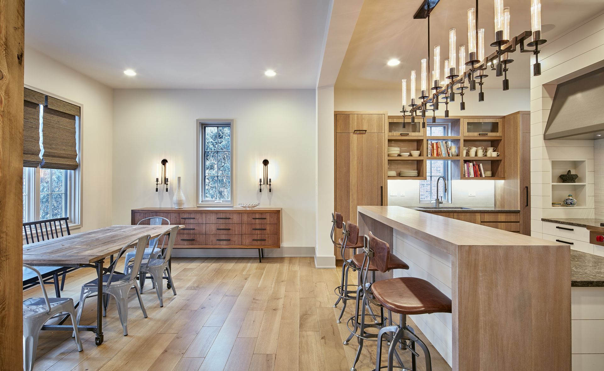 A kitchen with a table and chairs and a chandelier hanging from the ceiling.