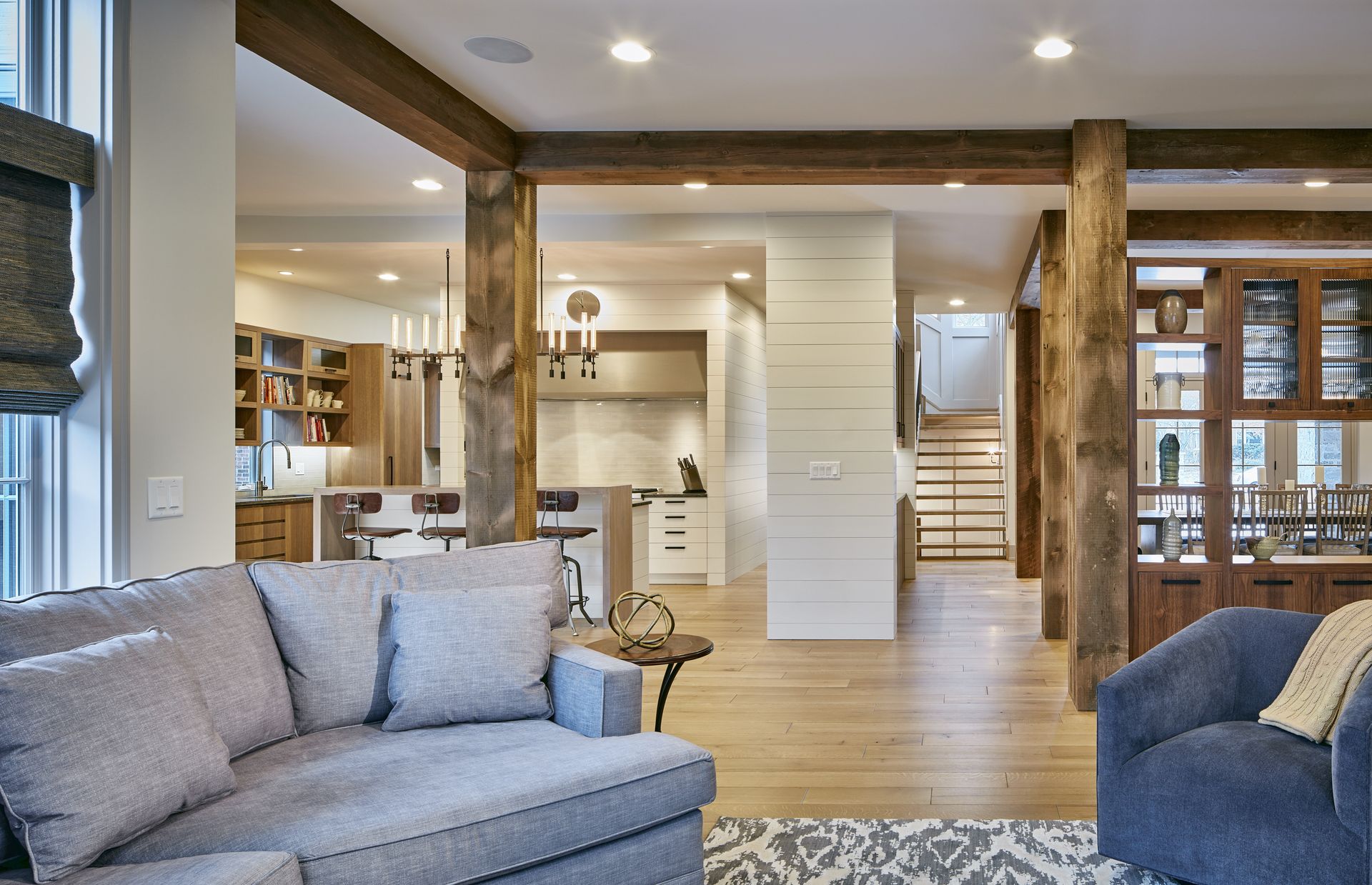 A living room with a couch , chair , and table.