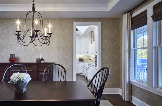 A dining room with a table and chairs and a chandelier