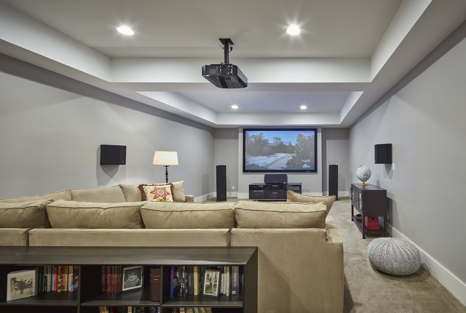 A living room with a projector screen and a couch.