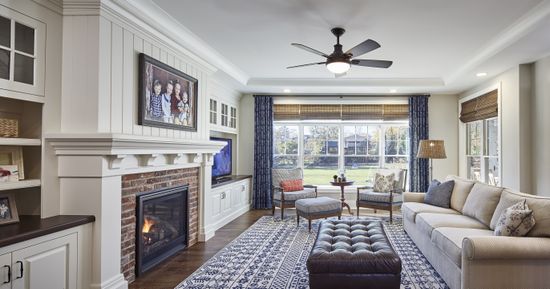 There is a fireplace in the middle of the living room.