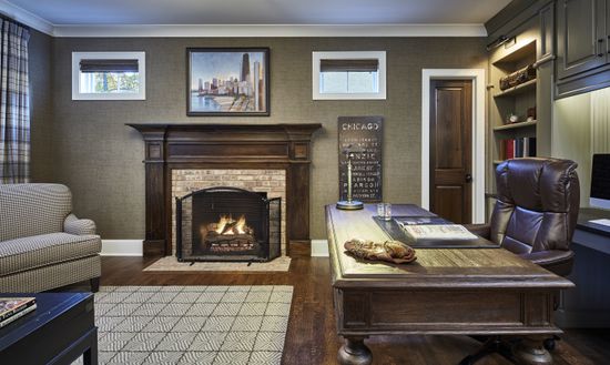 A living room with a fireplace and a desk