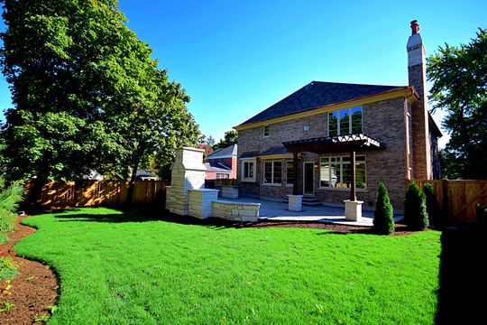 A large house with a large lawn in front of it