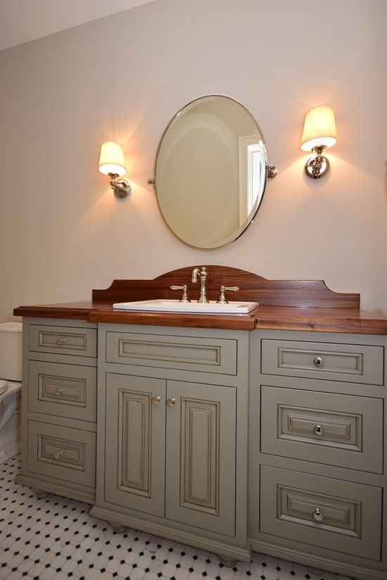 A bathroom with a sink and a mirror on the wall