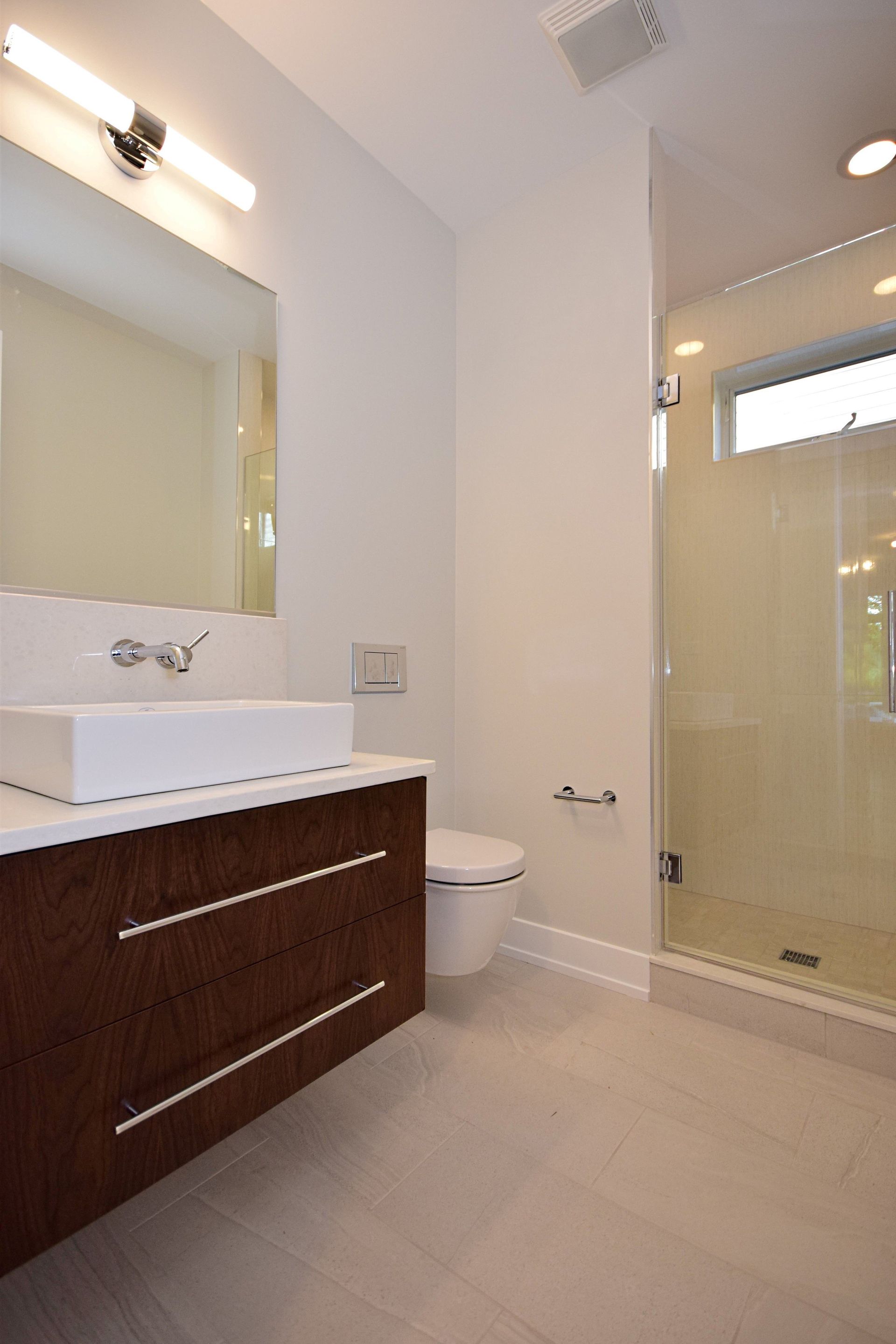 A bathroom with a sink , toilet , and shower.