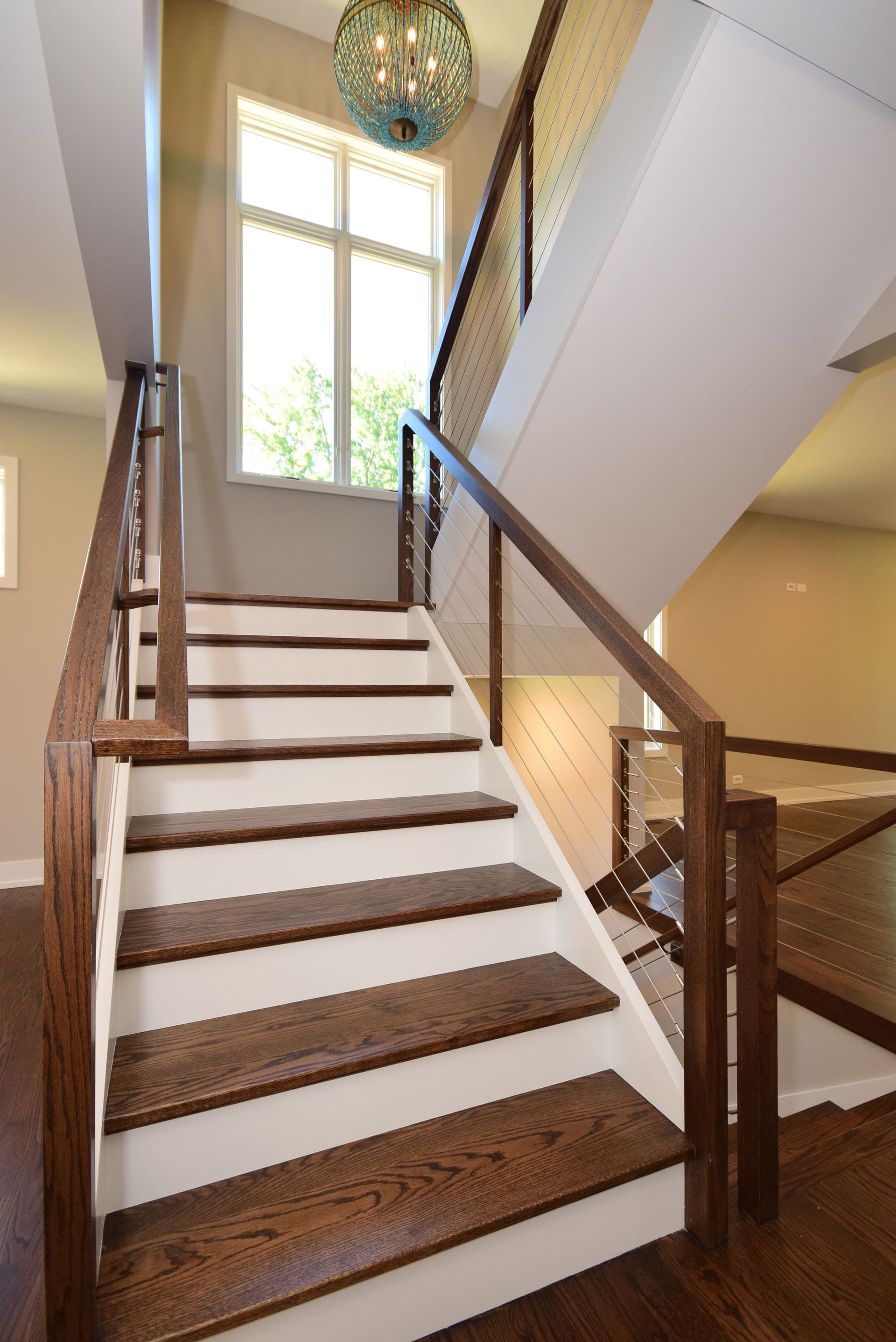 A staircase with white steps and brown steps in a house
