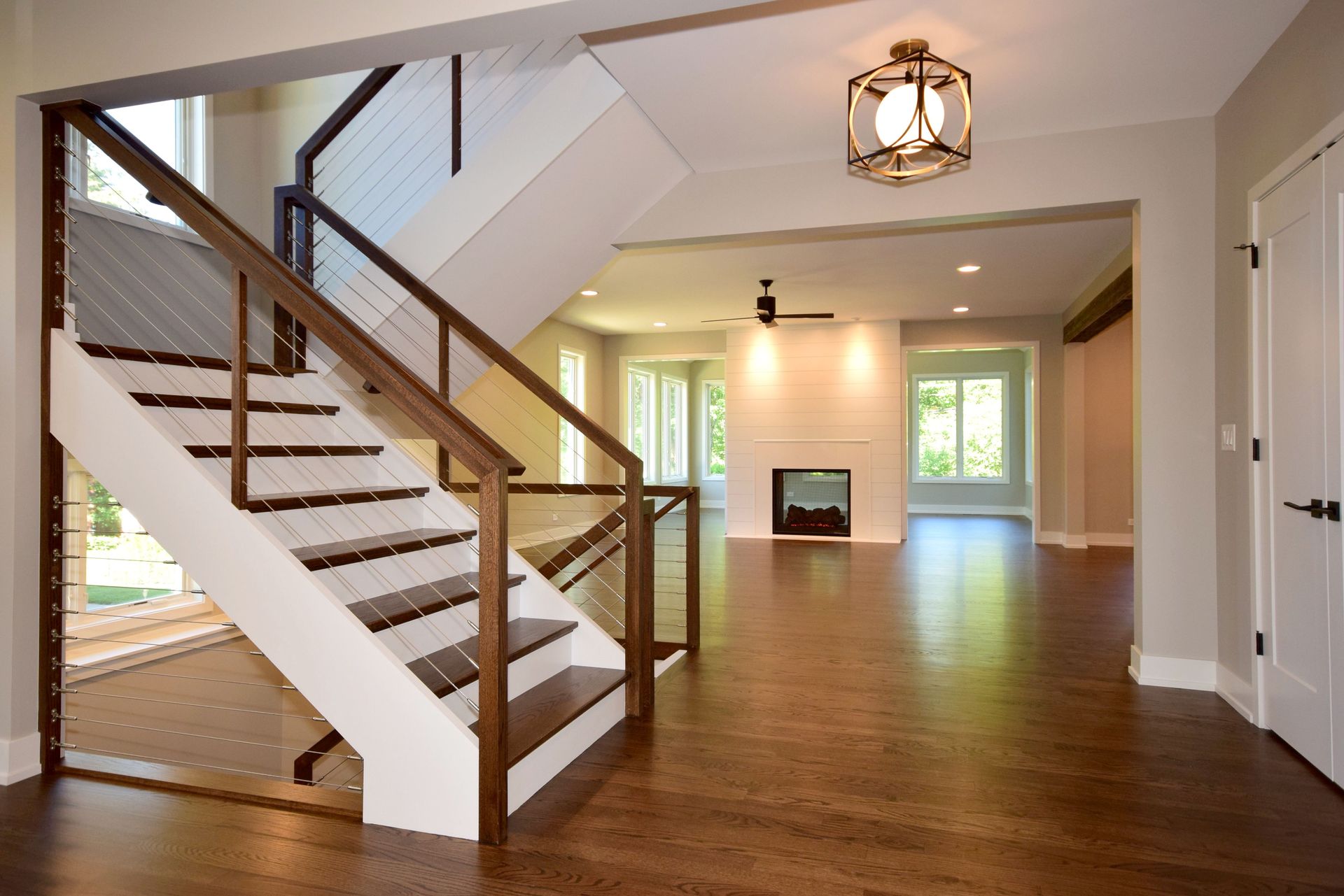 An empty room with a staircase leading up to the second floor
