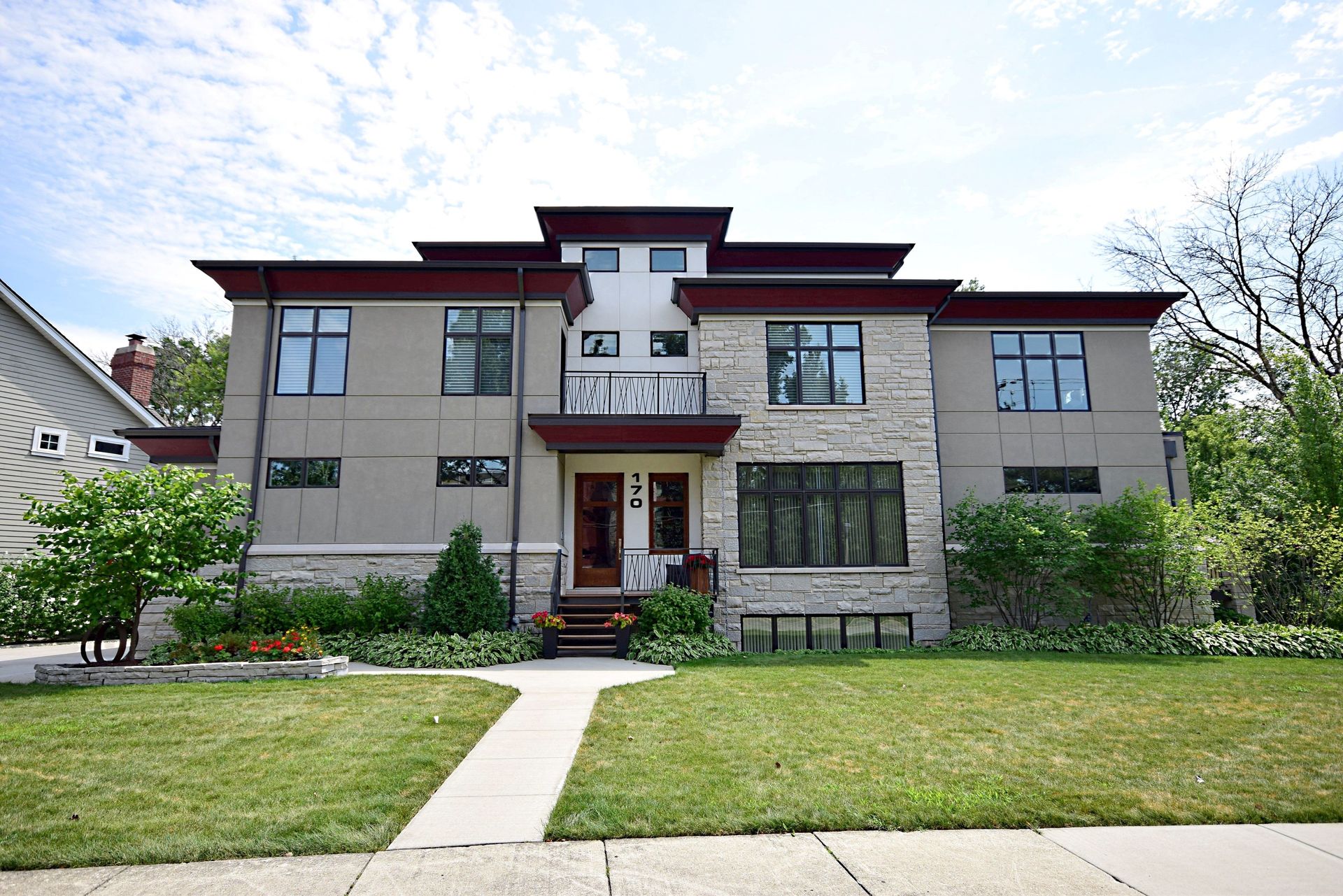 A large house with a lush green lawn in front of it.