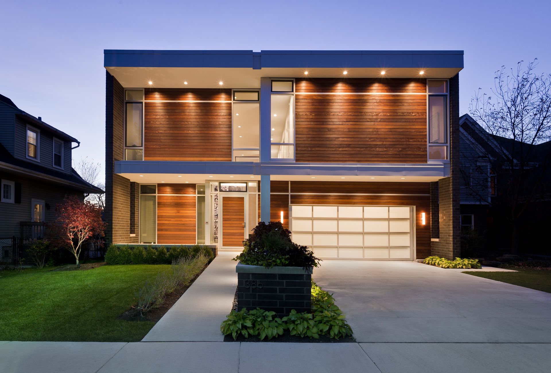 The front of a modern house with a large garage door