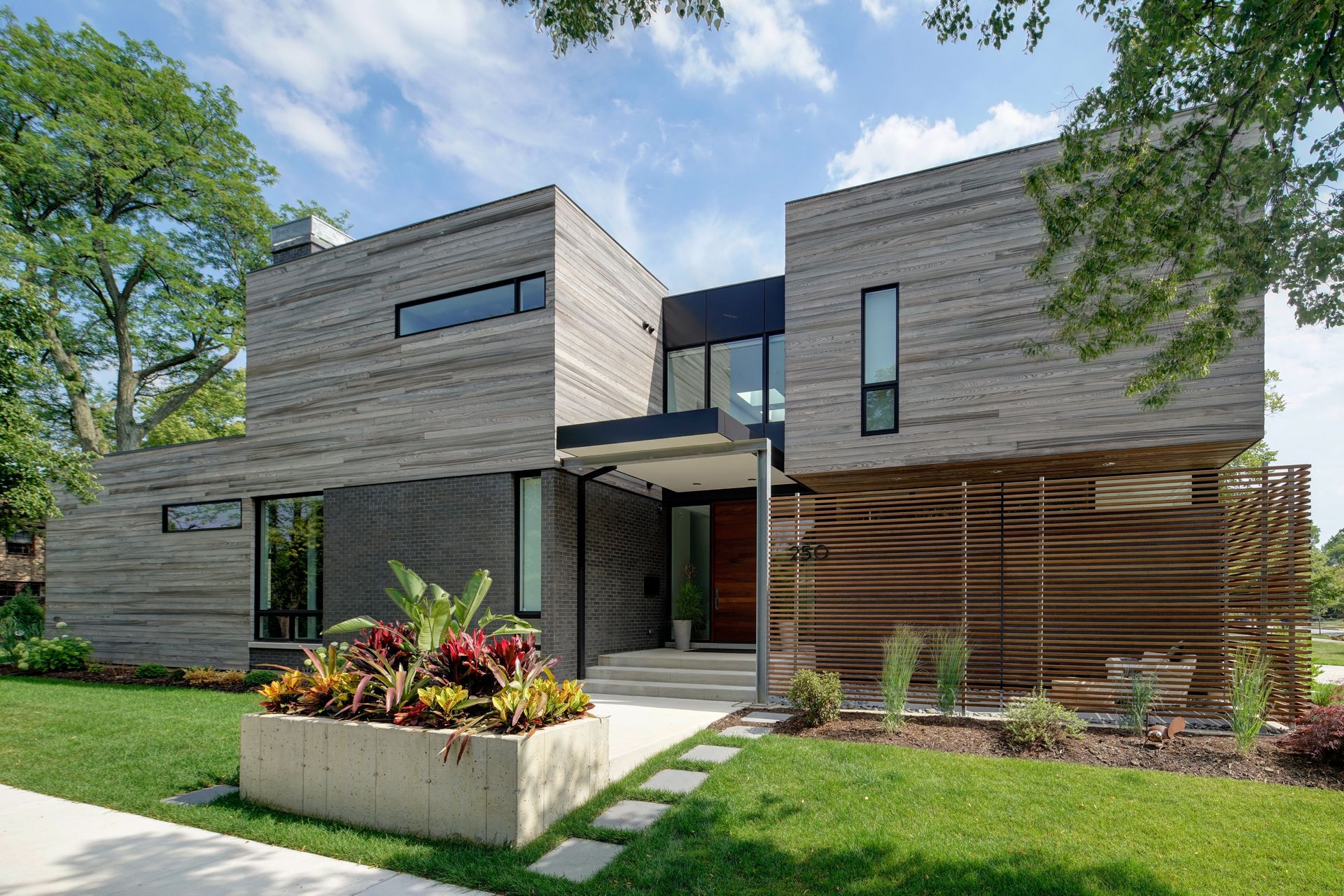 A modern house with a planter in front of it