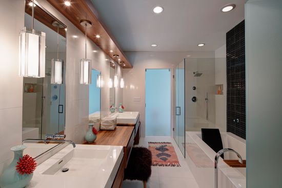 A bathroom with two sinks , a tub and a shower.
