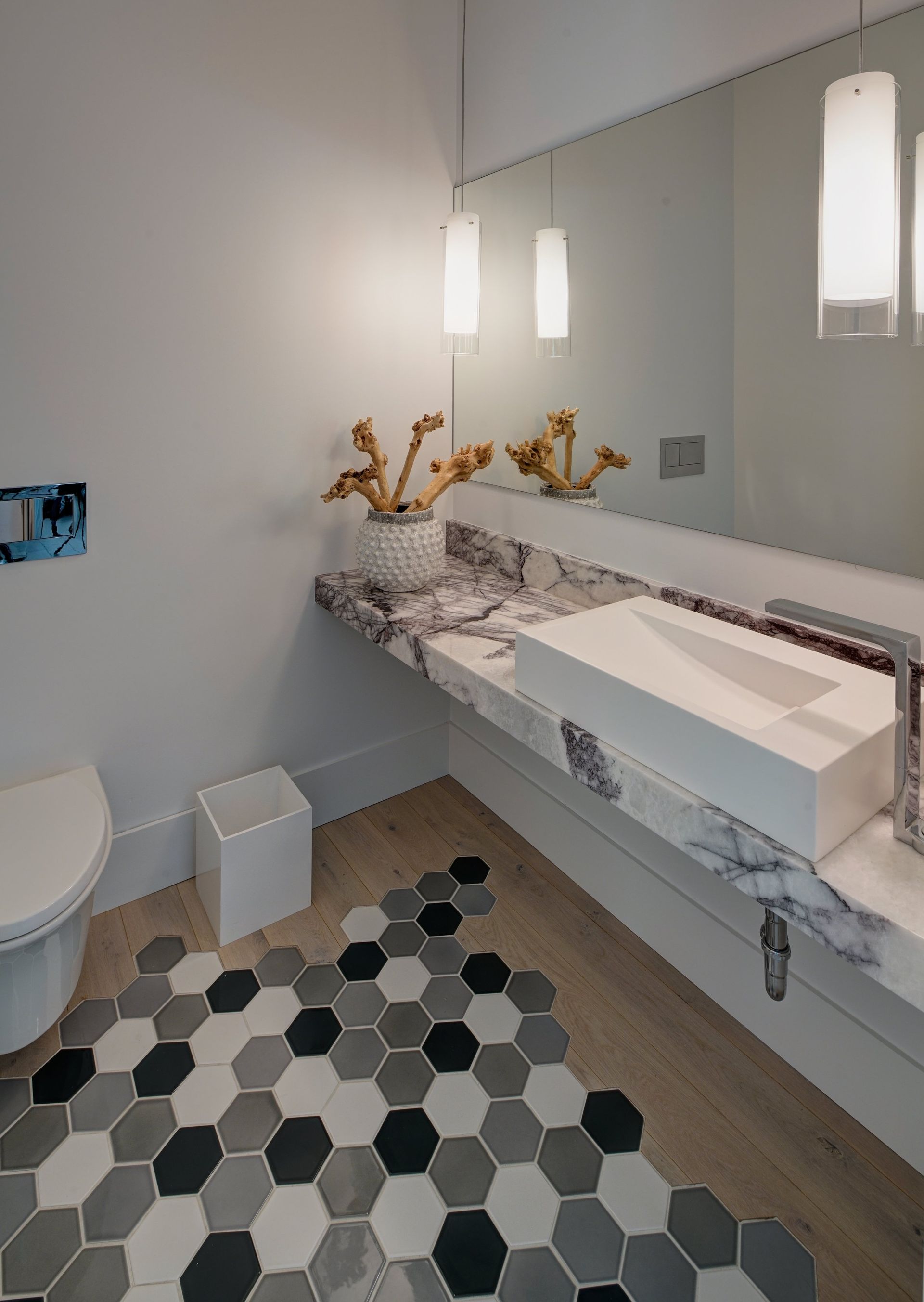 A bathroom with a toilet a sink and a mirror