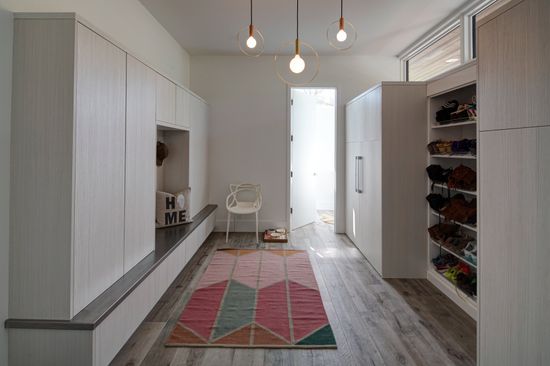 There is a rug on the floor in the middle of the room.
