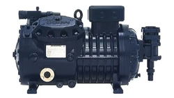 Black industrial compressor unit with hoses and mounting feet, isolated on a white background