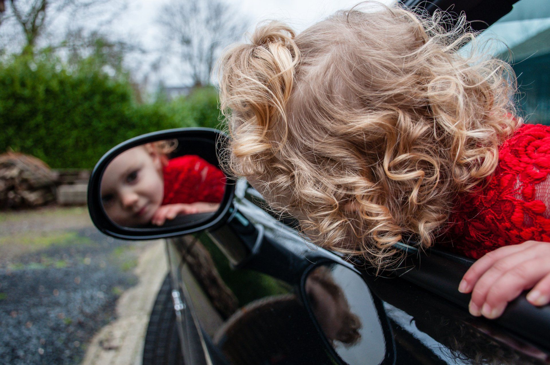 Windshield Replacement — Toddler Looking at Her Reflection in Car Mirror in Warminster, PA Windshield Replacement — Toddler Looking at Her Reflection in Car Mirror in Warminster, PA